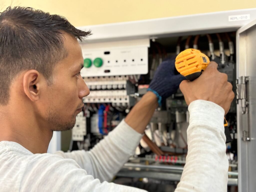 Licensed electrician upgrading a residential electrical panel in Hueytown, AL