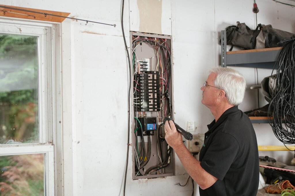 Licensed electrician inspecting a residential electrical panel before an upgrade in Alabaster, AL