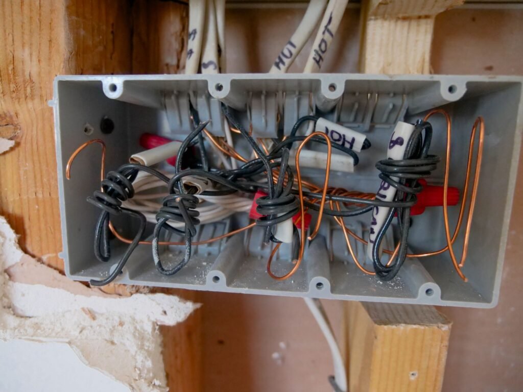 Outdated open electrical switchboard with tangled wiring, a common sign of an overdue panel upgrade in Ashville, AL